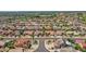 Aerial view of a desert home in a residential area with meticulously landscaped yards and palm trees at 15539 W La Salinas Ln, Surprise, AZ 85374