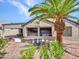 Charming backyard showcasing desert landscaping and an inviting covered patio space at 15539 W La Salinas Ln, Surprise, AZ 85374