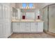 Bathroom with double sinks, tile floors, and large mirrors, offering style and functionality at 15539 W La Salinas Ln, Surprise, AZ 85374