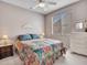 Cozy bedroom with a ceiling fan, window, and matching nightstands and dresser at 15539 W La Salinas Ln, Surprise, AZ 85374