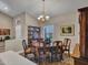Well-lit dining room with hardwood furniture, view of living room, and ample seating at 15539 W La Salinas Ln, Surprise, AZ 85374