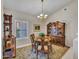 Dining area showcasing an oval table, hutch, chandelier, and natural light at 15539 W La Salinas Ln, Surprise, AZ 85374