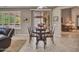 Cozy dining room features a wooden table, chairs, and natural light from a window at 15539 W La Salinas Ln, Surprise, AZ 85374