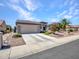 Single Gathering home with a well-manicured lawn and paved driveway at 15539 W La Salinas Ln, Surprise, AZ 85374