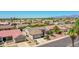 Charming desert home featuring well-maintained landscaping, a three-car garage, and lush greenery at 15539 W La Salinas Ln, Surprise, AZ 85374