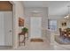 Inviting foyer with neutral tones, tiled floor, and a view into the dining room at 15539 W La Salinas Ln, Surprise, AZ 85374