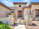 Charming front entrance with decorative gate and well-maintained landscaping at 15539 W La Salinas Ln, Surprise, AZ 85374