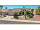 Charming single-story home with desert landscaping, mature trees, and a two-car garage at 15539 W La Salinas Ln, Surprise, AZ 85374