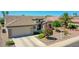 Attractive home featuring drought-tolerant landscaping, a two-car garage, and a welcoming entrance at 15539 W La Salinas Ln, Surprise, AZ 85374