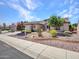 Charming home showcasing desert landscaping and mature desert flora in the front yard at 15539 W La Salinas Ln, Surprise, AZ 85374