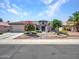 Charming desert home displaying a beautifully landscaped front yard with xeriscaping at 15539 W La Salinas Ln, Surprise, AZ 85374