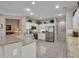 Modern kitchen with granite counters, white cabinets, and stainless steel appliances at 15539 W La Salinas Ln, Surprise, AZ 85374
