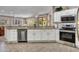 Kitchen with stainless appliances, white cabinets, countertops and tile floors at 15539 W La Salinas Ln, Surprise, AZ 85374