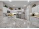 Modern kitchen with granite countertops, white cabinets, and stainless steel appliances at 15539 W La Salinas Ln, Surprise, AZ 85374