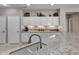 Kitchen featuring white cabinets, granite countertops, and stainless sink at 15539 W La Salinas Ln, Surprise, AZ 85374
