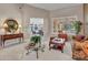 Spacious living room with tiled flooring, comfortable furniture, and access to other living spaces at 15539 W La Salinas Ln, Surprise, AZ 85374