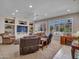 Spacious living room with built-in shelving, neutral tones, recessed lighting, and comfortable seating at 15539 W La Salinas Ln, Surprise, AZ 85374