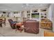 Open-concept living room with tile floors, ample seating, and a view into the kitchen at 15539 W La Salinas Ln, Surprise, AZ 85374