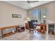 Well-lit home office with a large desk, storage, and a beverage cooler at 15539 W La Salinas Ln, Surprise, AZ 85374