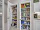 Well-stocked pantry shelves provide ample storage in this home's kitchen, perfect for organization at 15539 W La Salinas Ln, Surprise, AZ 85374