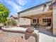 Covered patio with ceiling fans, furniture, and bbq area for outdoor entertainment at 15539 W La Salinas Ln, Surprise, AZ 85374