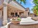 Entertain on the covered patio with potted flowers, seating and grilling area at 15539 W La Salinas Ln, Surprise, AZ 85374