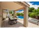 The backyard features a patio, a dining table, a pool, and lounge chairs at 1707 W Stanford Ave, Gilbert, AZ 85233