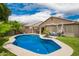 Inviting backyard with a private pool, patio seating, and lush greenery, perfect for outdoor relaxation at 1707 W Stanford Ave, Gilbert, AZ 85233