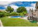 Backyard with lush landscaping, a well-maintained pool, a patio and comfortable outdoor seating at 1707 W Stanford Ave, Gilbert, AZ 85233