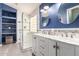 The bathroom features a double sink vanity, a glass door shower, and blue painted walls at 1707 W Stanford Ave, Gilbert, AZ 85233