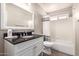 Bright bathroom features a granite vanity, a large mirror, and a shower with a tub at 1707 W Stanford Ave, Gilbert, AZ 85233