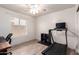 Bedroom featuring a ceiling fan, a desk, a computer, and exercise equipment at 1707 W Stanford Ave, Gilbert, AZ 85233