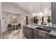 Kitchen with stainless steel appliances, granite countertops, a breakfast nook and a view to the living room at 1707 W Stanford Ave, Gilbert, AZ 85233
