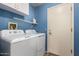 Laundry room featuring side-by-side washer and dryer, overhead cabinets, and a wire rack at 1707 W Stanford Ave, Gilbert, AZ 85233