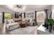Bright living room featuring a large sectional sofa, modern decor, and large windows for ample natural light at 1707 W Stanford Ave, Gilbert, AZ 85233
