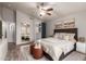 Beautiful bedroom featuring a ceiling fan, ensuite, a comfortable bed, and stylish decorations at 1707 W Stanford Ave, Gilbert, AZ 85233