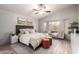 Cozy main bedroom showcasing a bed with soft bedding, a seating area, and lots of natural light at 1707 W Stanford Ave, Gilbert, AZ 85233