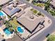 Stunning aerial view showcasing a lush backyard with a sparkling pool, well-manicured landscaping, and solar panels at 18036 W San Miguel Ave, Litchfield Park, AZ 85340