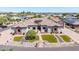 Stunning aerial view of the property showcasing the tile roof, manicured landscaping, and paver driveway at 18036 W San Miguel Ave, Litchfield Park, AZ 85340