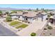 Impressive aerial view of the home featuring lush landscaping, a tile roof, and a paver driveway at 18036 W San Miguel Ave, Litchfield Park, AZ 85340