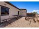 Side yard with gravel and access to the back at 18036 W San Miguel Ave, Litchfield Park, AZ 85340