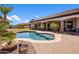 Backyard paradise featuring a sparkling pool, mature landscaping, and a covered patio at 18036 W San Miguel Ave, Litchfield Park, AZ 85340