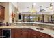 Open bar area featuring granite counters, rich wood cabinetry, and a view to outdoor living at 18036 W San Miguel Ave, Litchfield Park, AZ 85340
