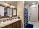 The bathroom boasts a dual sink vanity with granite countertop and stylish fixtures, and a separate shower at 18036 W San Miguel Ave, Litchfield Park, AZ 85340