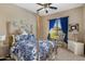 Charming bedroom with a decorative bed frame, blue accents, and ample natural light from the window at 18036 W San Miguel Ave, Litchfield Park, AZ 85340