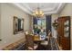 Formal dining room featuring a chandelier, a large mirror, and elegant decor for sophisticated entertaining at 18036 W San Miguel Ave, Litchfield Park, AZ 85340