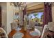 Elegant dining area features a wooden table, chandelier, and views of the backyard pool area at 18036 W San Miguel Ave, Litchfield Park, AZ 85340