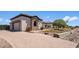 Charming single-story home with stone and stucco facade, plus a brick paver driveway, and manicured landscaping at 18036 W San Miguel Ave, Litchfield Park, AZ 85340