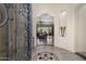 Elegant foyer with arched entrance and decorative tile inlay, leading to an open living space at 18036 W San Miguel Ave, Litchfield Park, AZ 85340