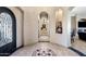 Elegant foyer with decorative tiled floor, arched doorways, niche display, and view into adjacent rooms at 18036 W San Miguel Ave, Litchfield Park, AZ 85340
